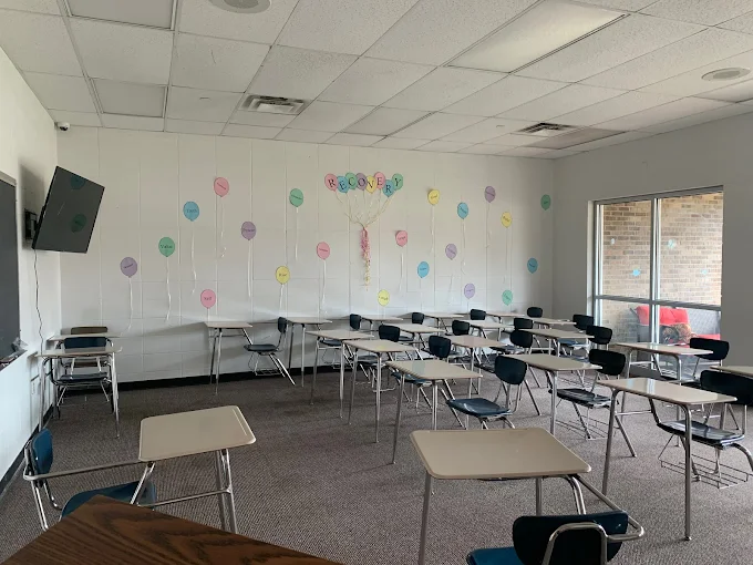 Classroom with desks and recovery-themed wall art