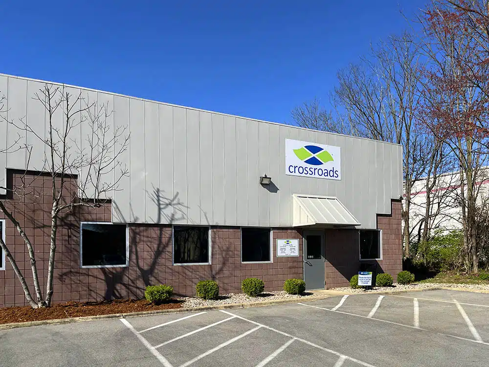 Clinic building with Crossroads sign and parking area