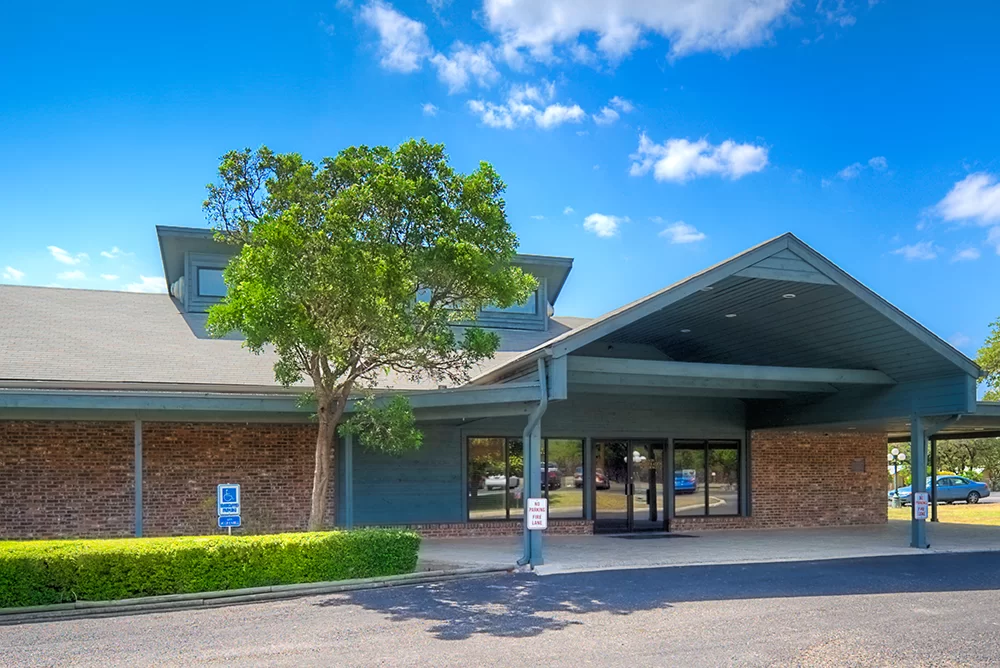 Front view of rehab facility with shaded drive-up area