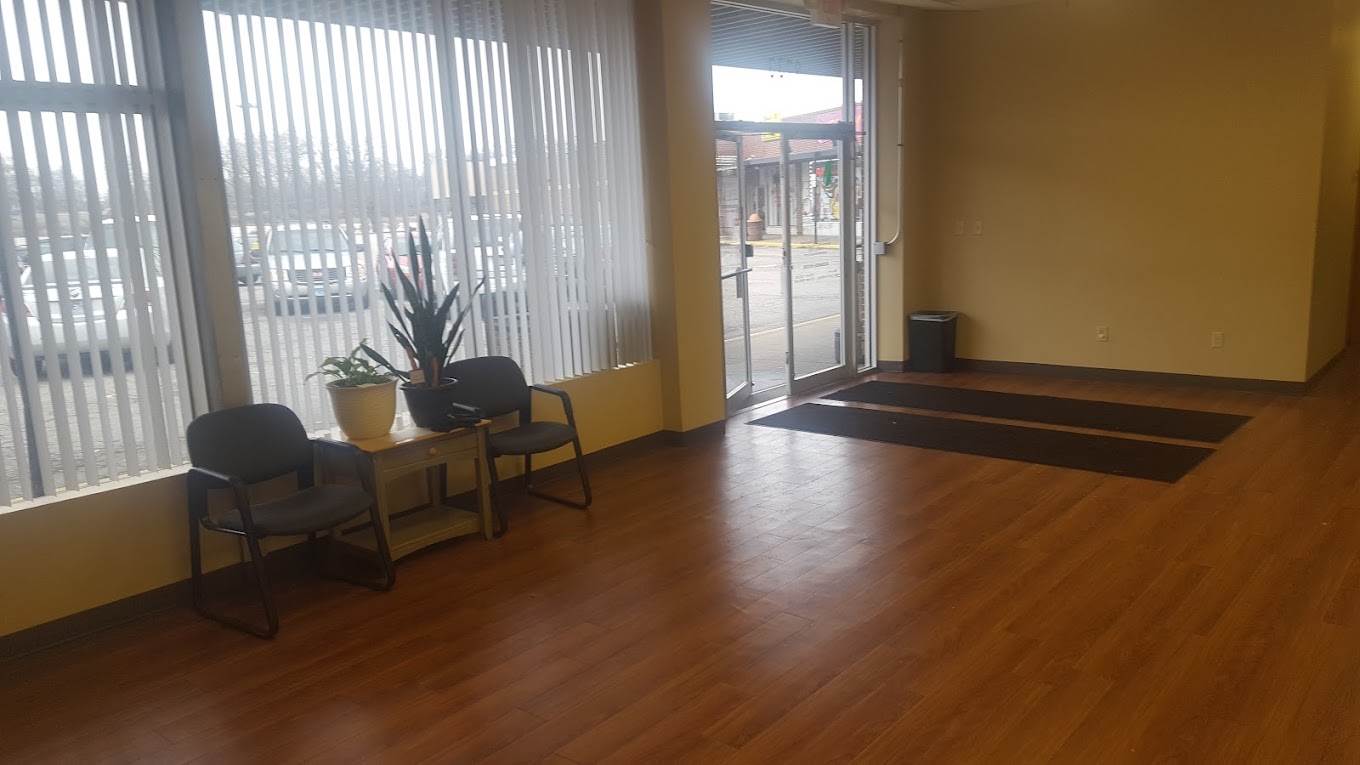 Lobby with wood floors, chairs, and large front windows