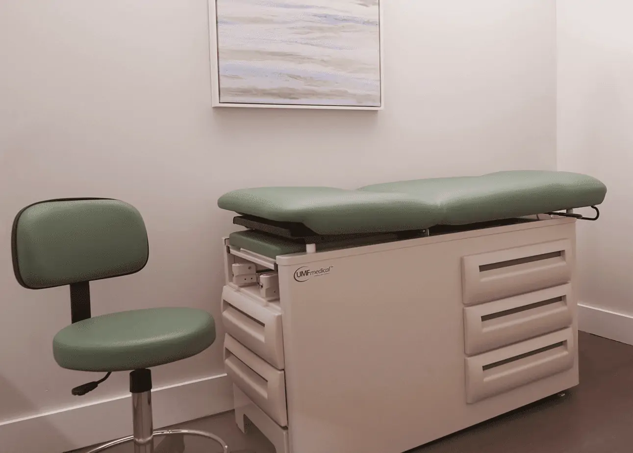 Medical exam chair and stool in private treatment room