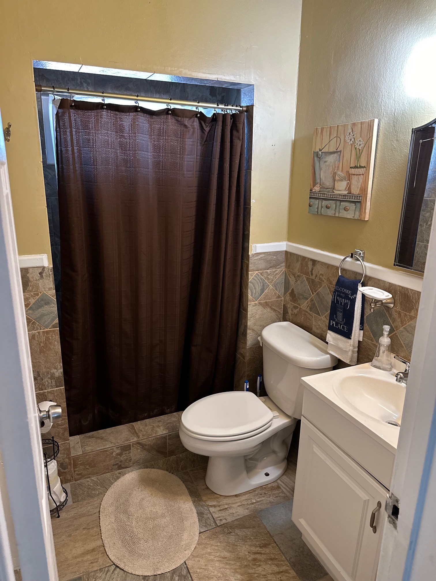 Bathroom with dark shower curtain and tiled walls