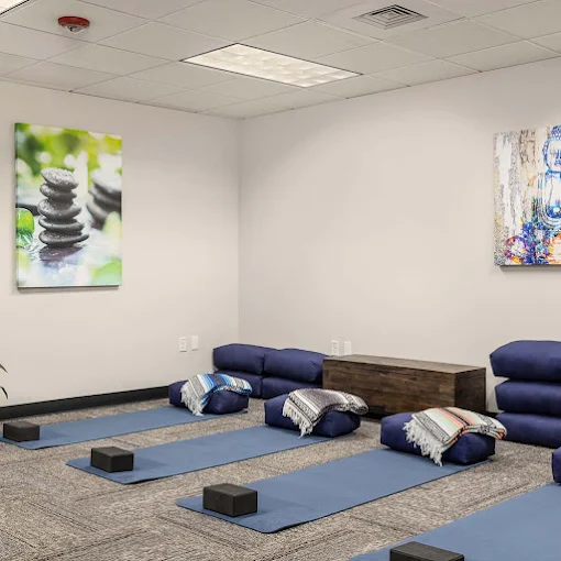 Yoga studio with mats, cushions, and calming artwork