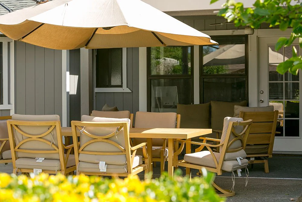 Patio table and chairs under large umbrella