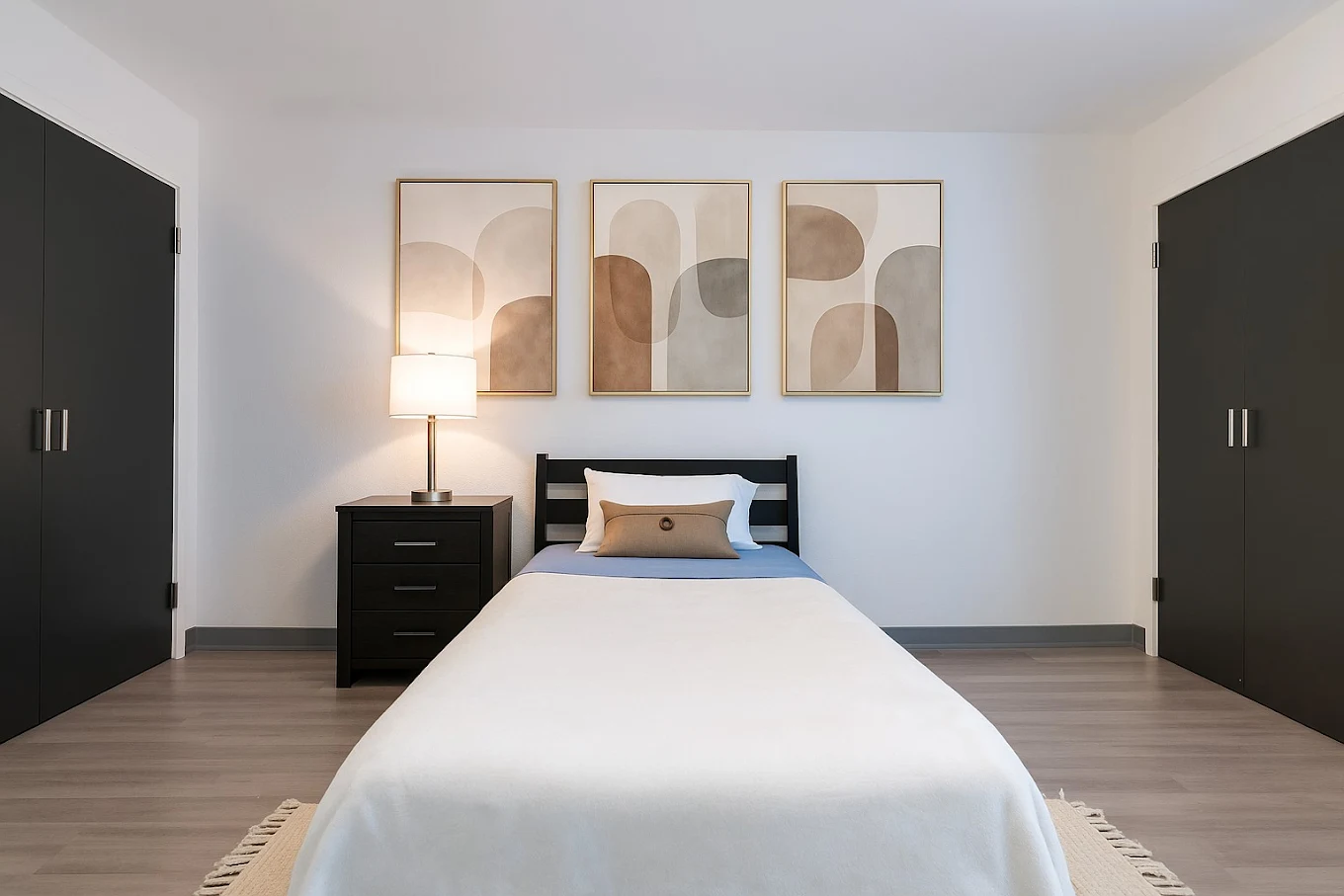 Private bedroom with twin bed, nightstand, and closet storage