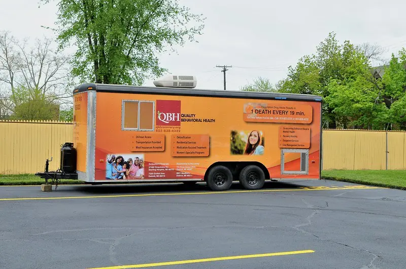  A mobile behavioral health unit with vibrant branding and information displayed.