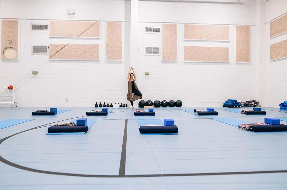 Yoga mats and equipment set up in indoor court