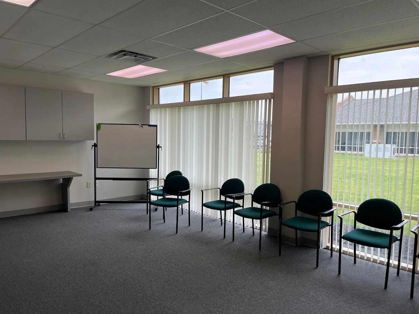 Meeting space with chairs near large windows