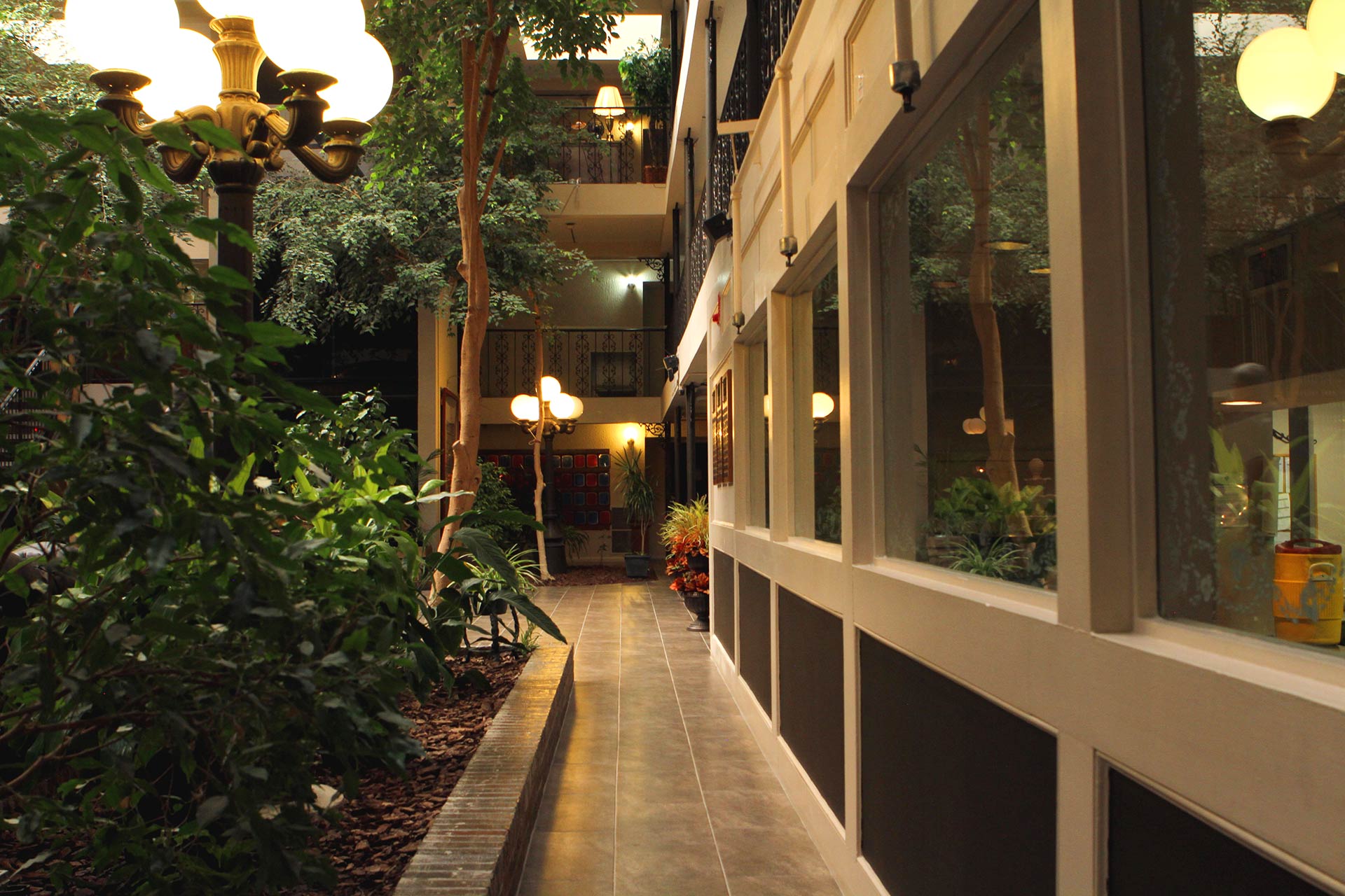 Hallway with plants and lamp posts inside rehab center