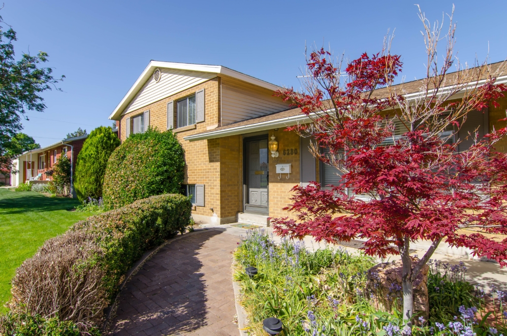 Brick home with green lawn and curved walkway