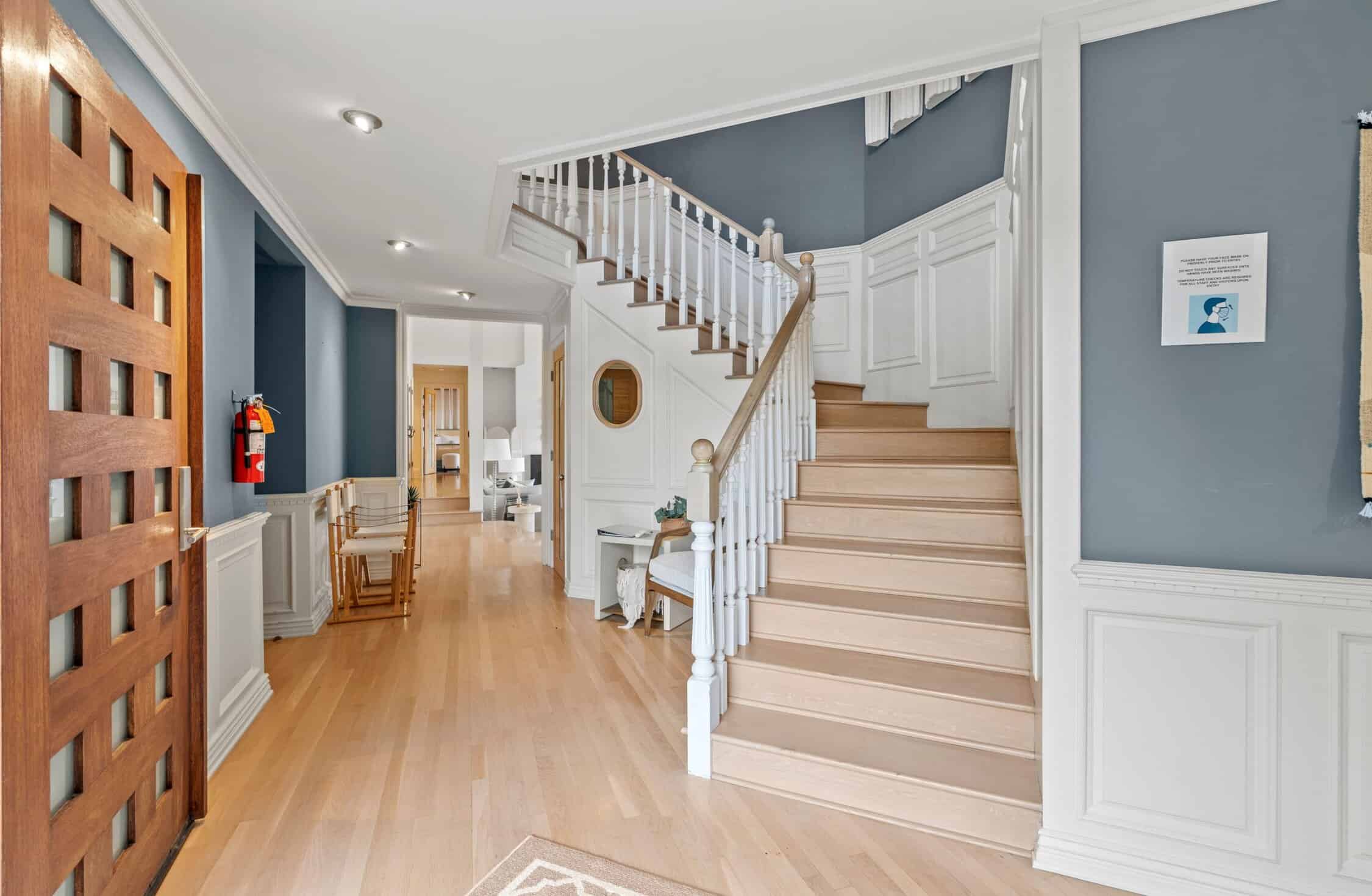 Elegant entryway with staircase and hardwood floors