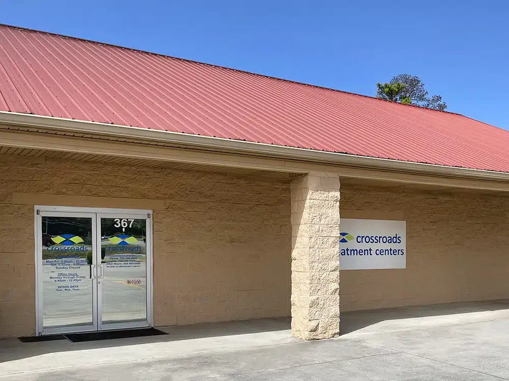 Exterior view of Crossroads clinic with red roof and entrance