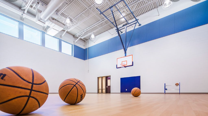 Indoor gym with basketball court and recreational space