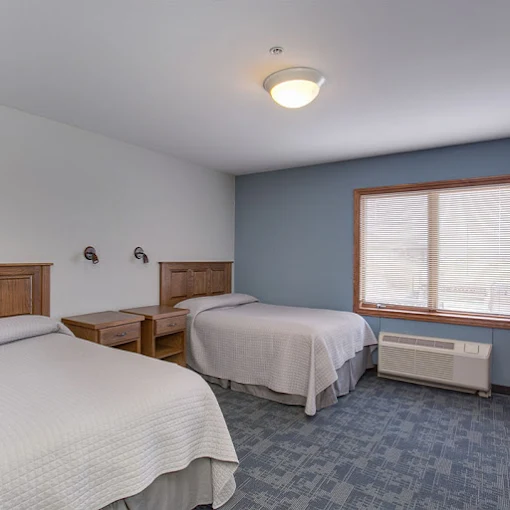 Bedroom with two twin beds and window