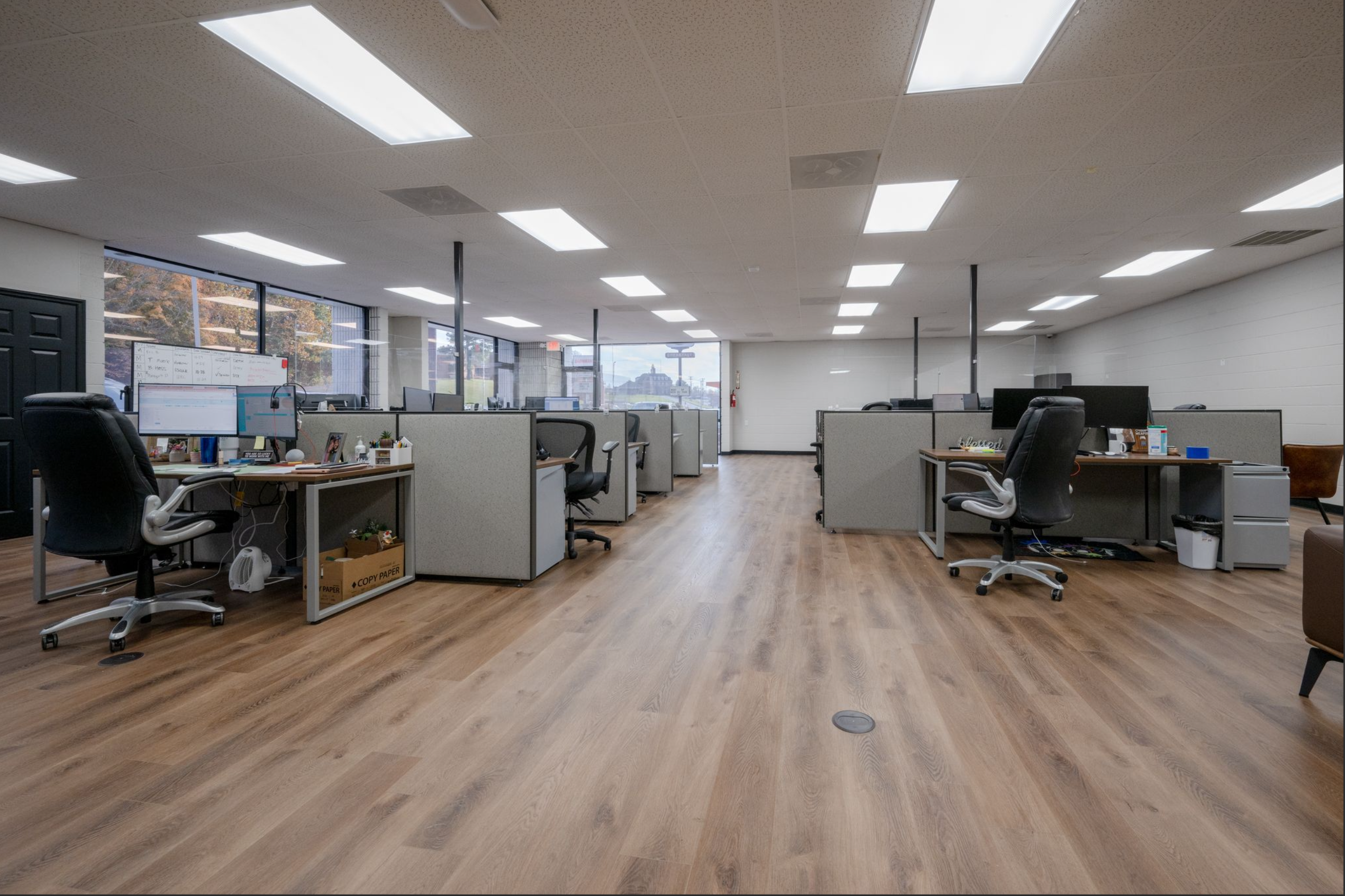 Open office with workstations and natural light from large windows