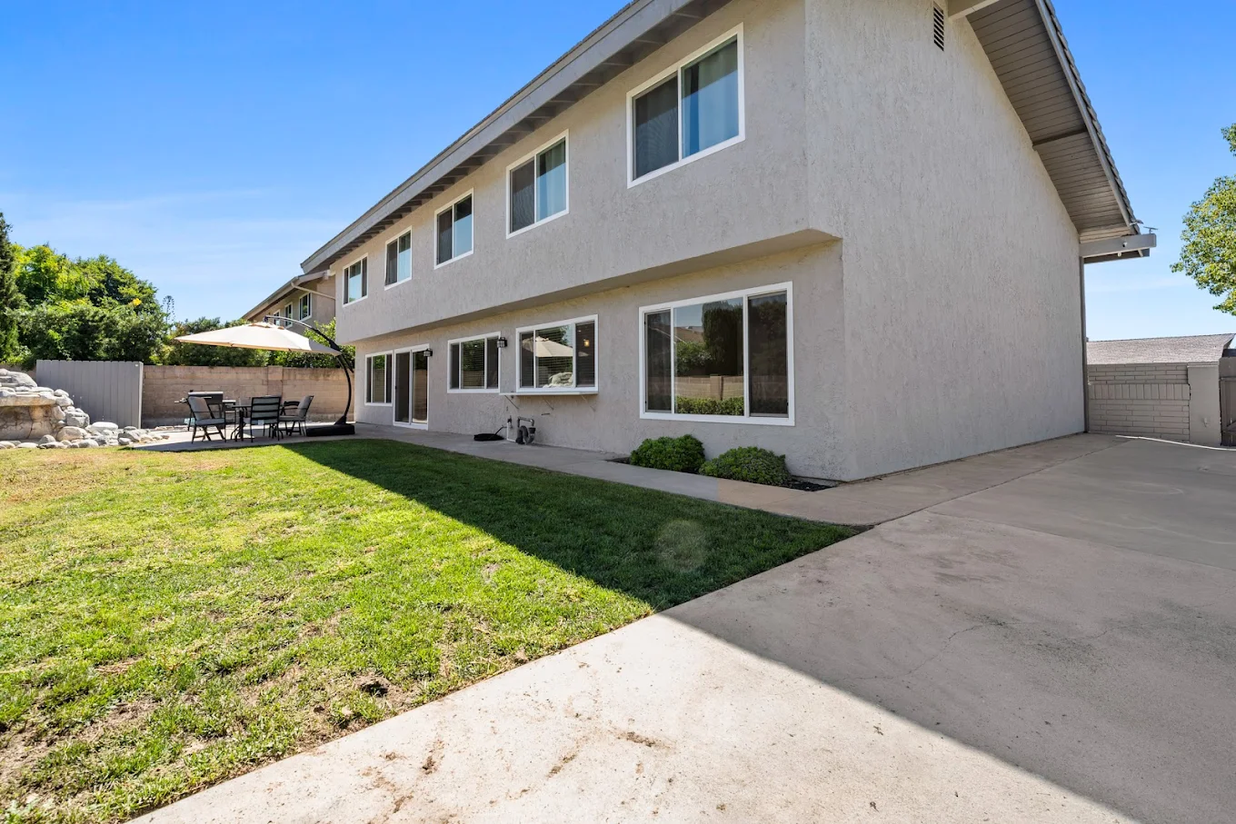 Spacious backyard with lawn and patio seating