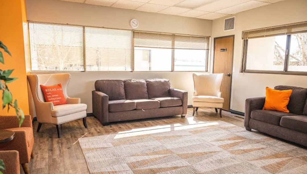 Sunlit client lounge with sofas and comfortable seating