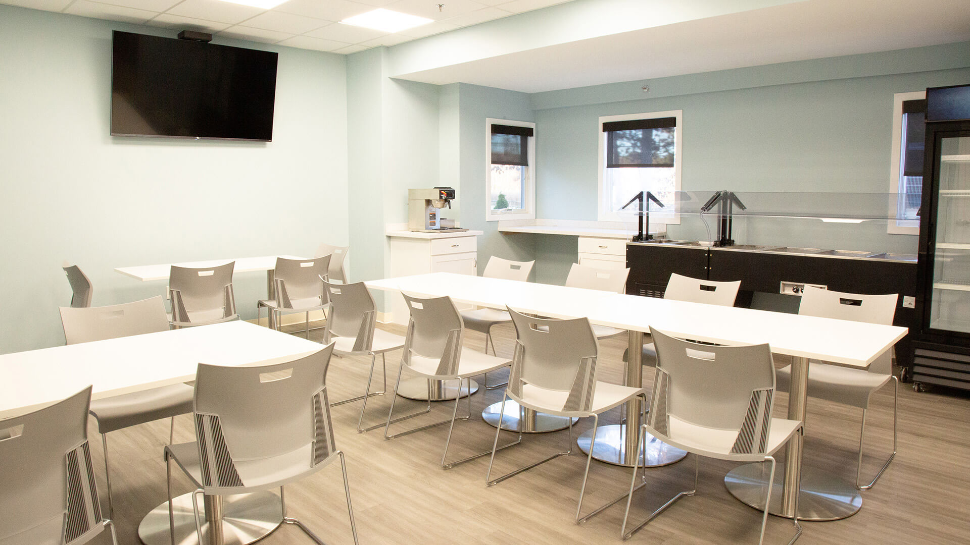 Dining area with seating, a TV, and a buffet station.