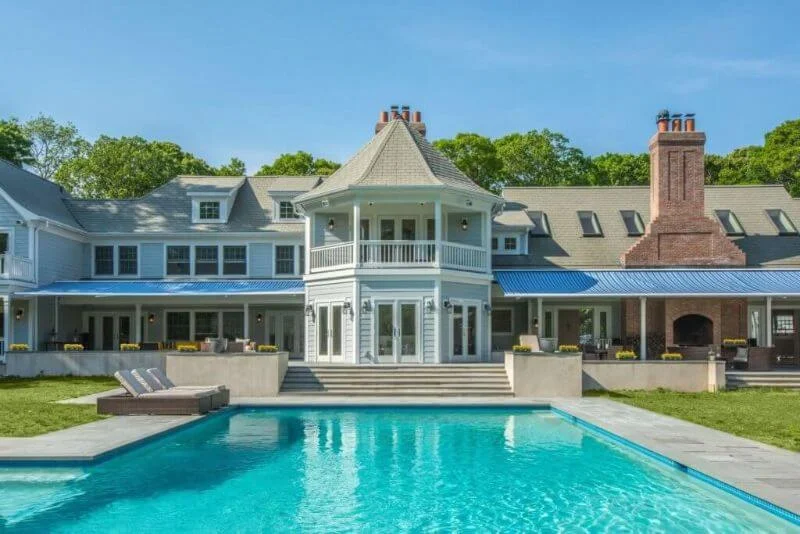 Exterior of large house with brick chimney and patio