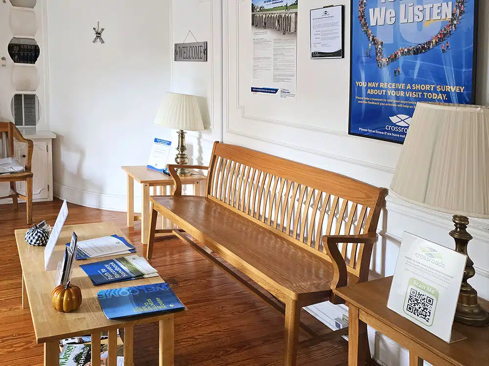 Waiting area with wooden bench, table, and informational brochures