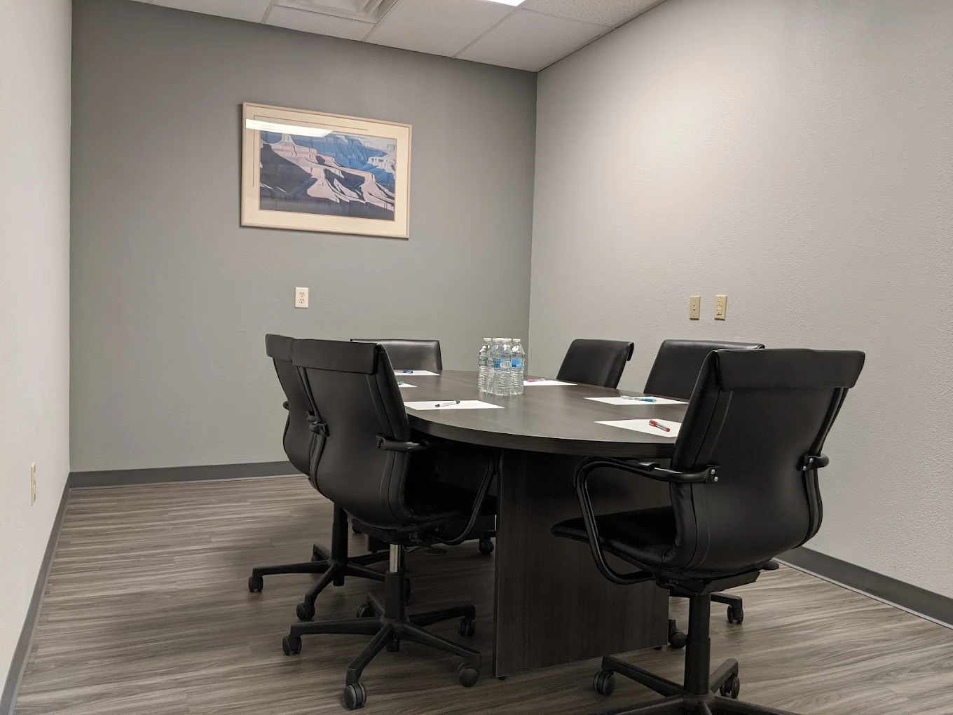 Meeting room with conference table and black office chairs