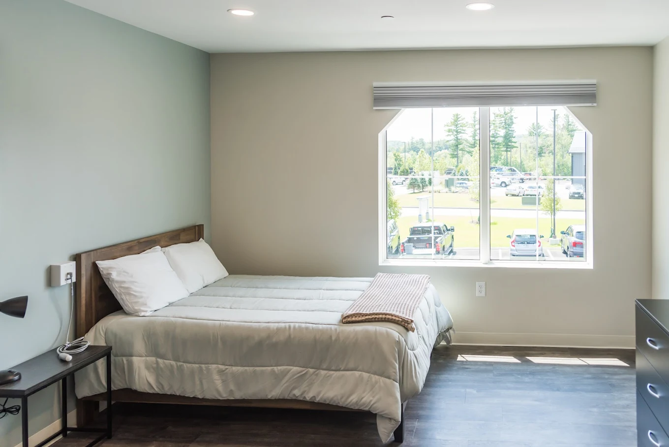 Bright bedroom with single bed and window view outside