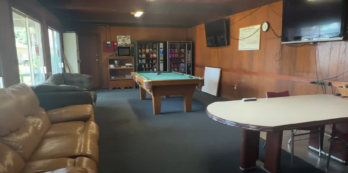 Lounge with couches, pool table, and snack machines