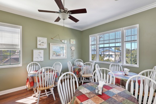 Bright dining room with colorful tablecloths and chairs