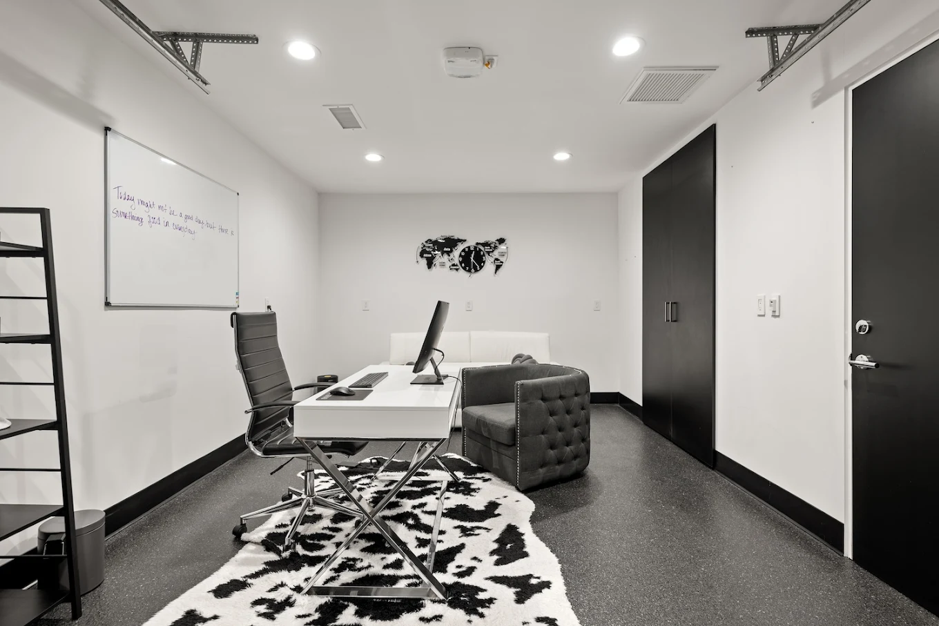 Modern therapy office with desk, sofa, and whiteboard