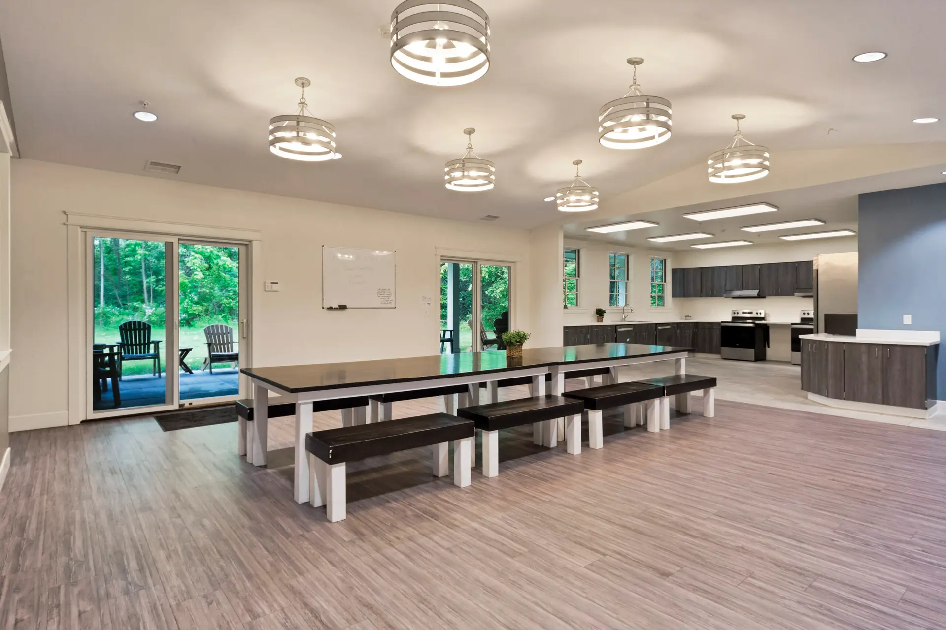 Open dining area with long tables connected to communal kitchen