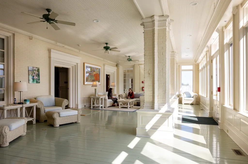 Sunlit lounge with seating and ocean-facing windows