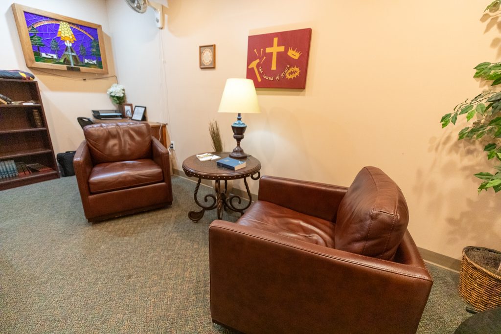 Private counseling room with leather chairs and side table