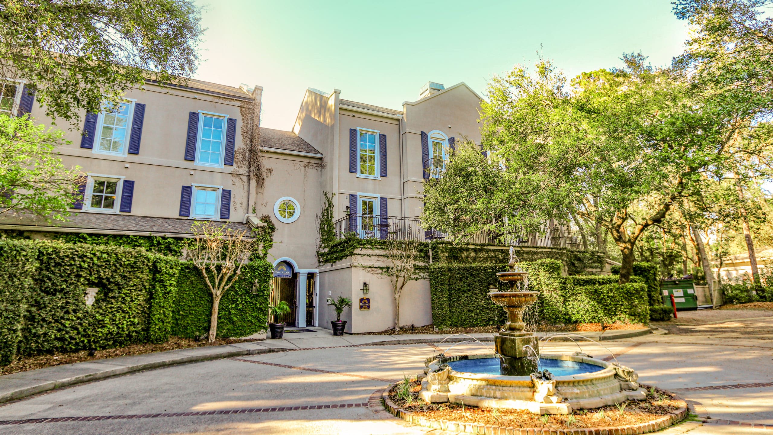 Tan building with courtyard and central fountain