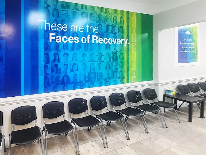 Waiting area with chairs and Faces of Recovery mura
