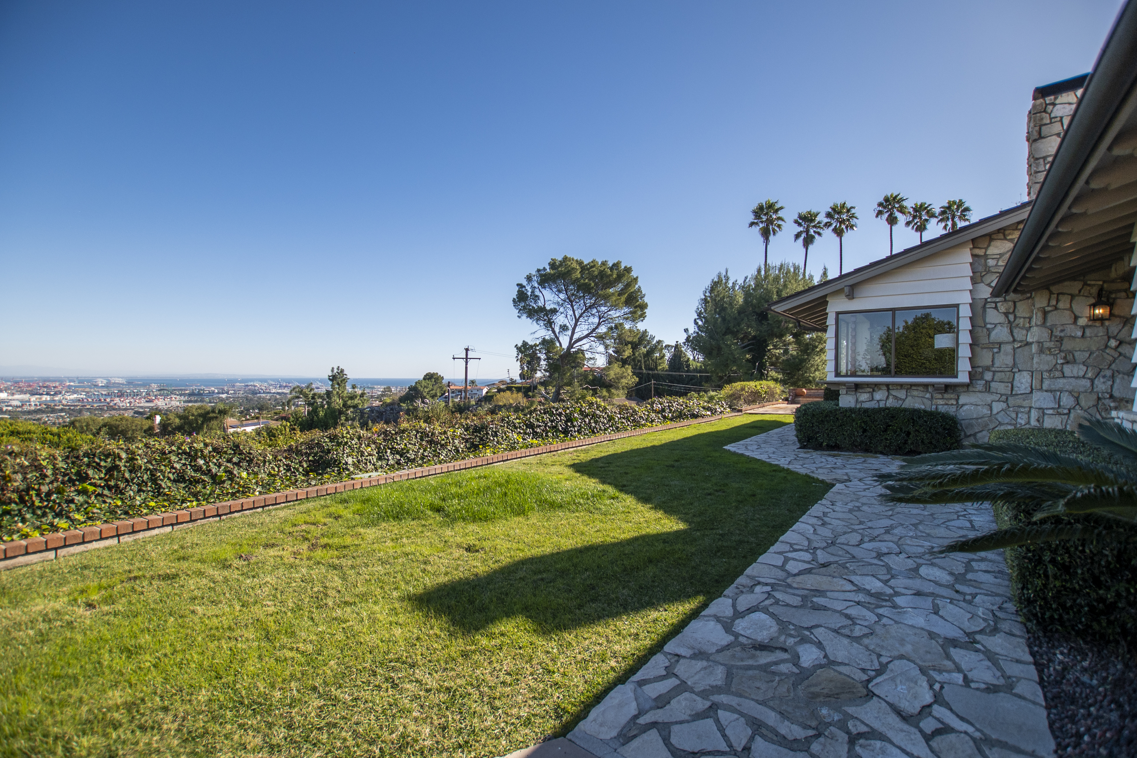 Outdoor view of a lush green lawn overlooking a cityscape
