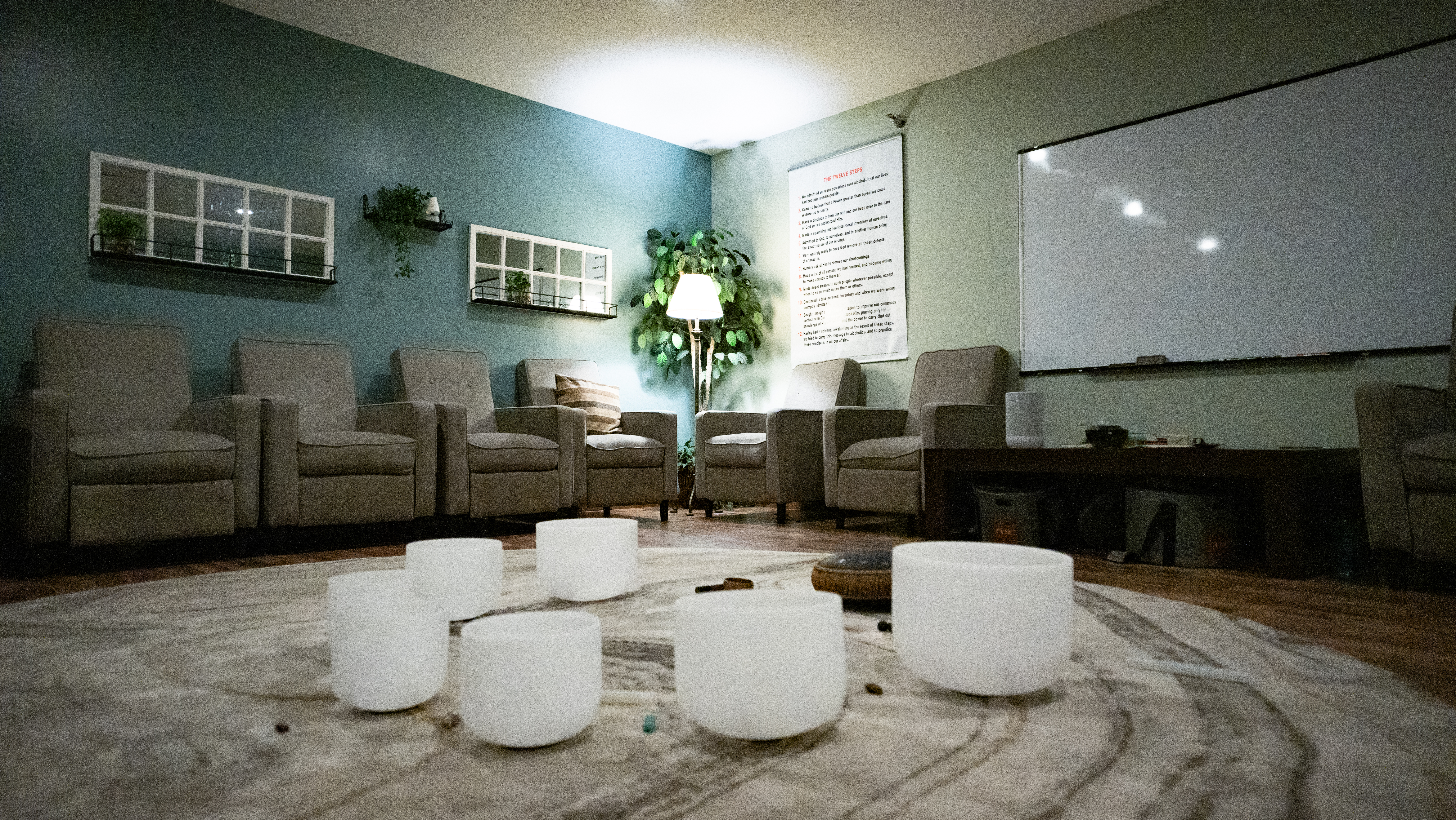 Group therapy circle with cushioned chairs and whiteboard
