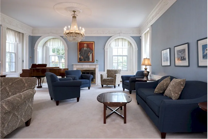 Comfortable community lounge with seating and piano.
