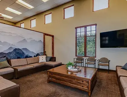 Comfortable resident lounge with sofas and TV