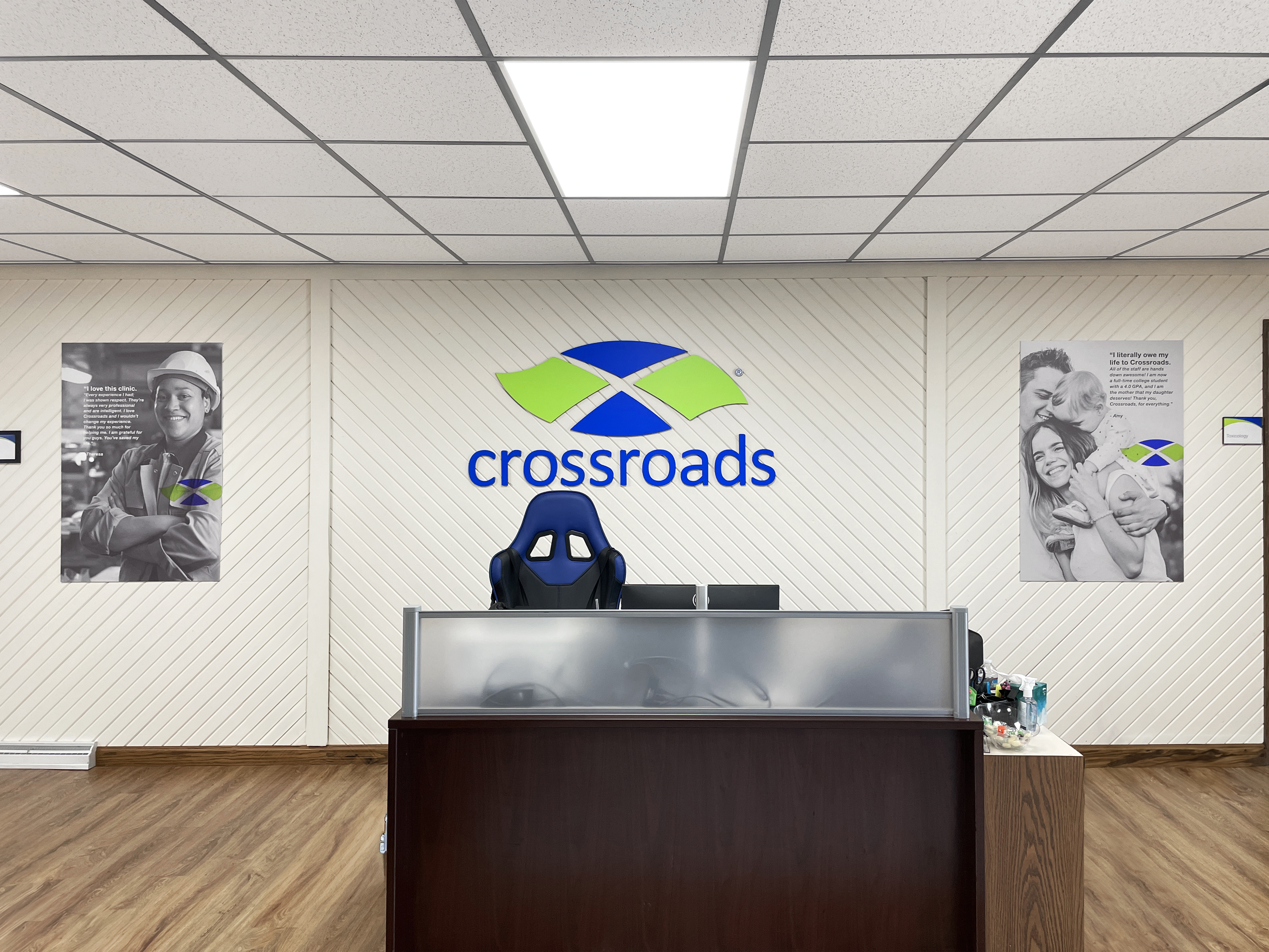 Reception desk with Crossroads logo on lobby wall