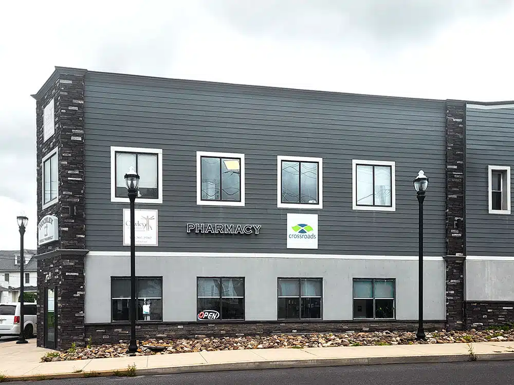Exterior view of clinic building with pharmacy signage