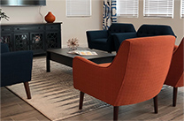 Living area with orange and navy chairs