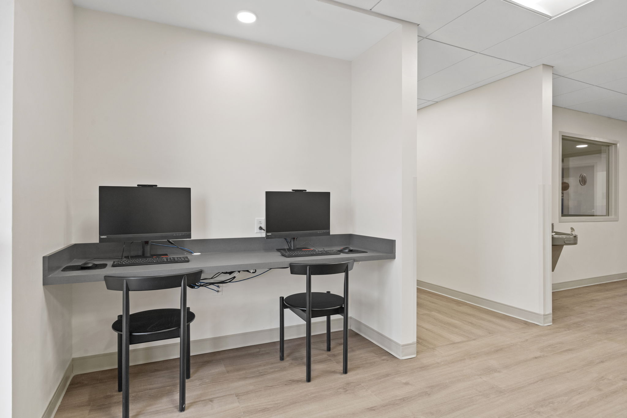 A small workstation with two computers for residents.