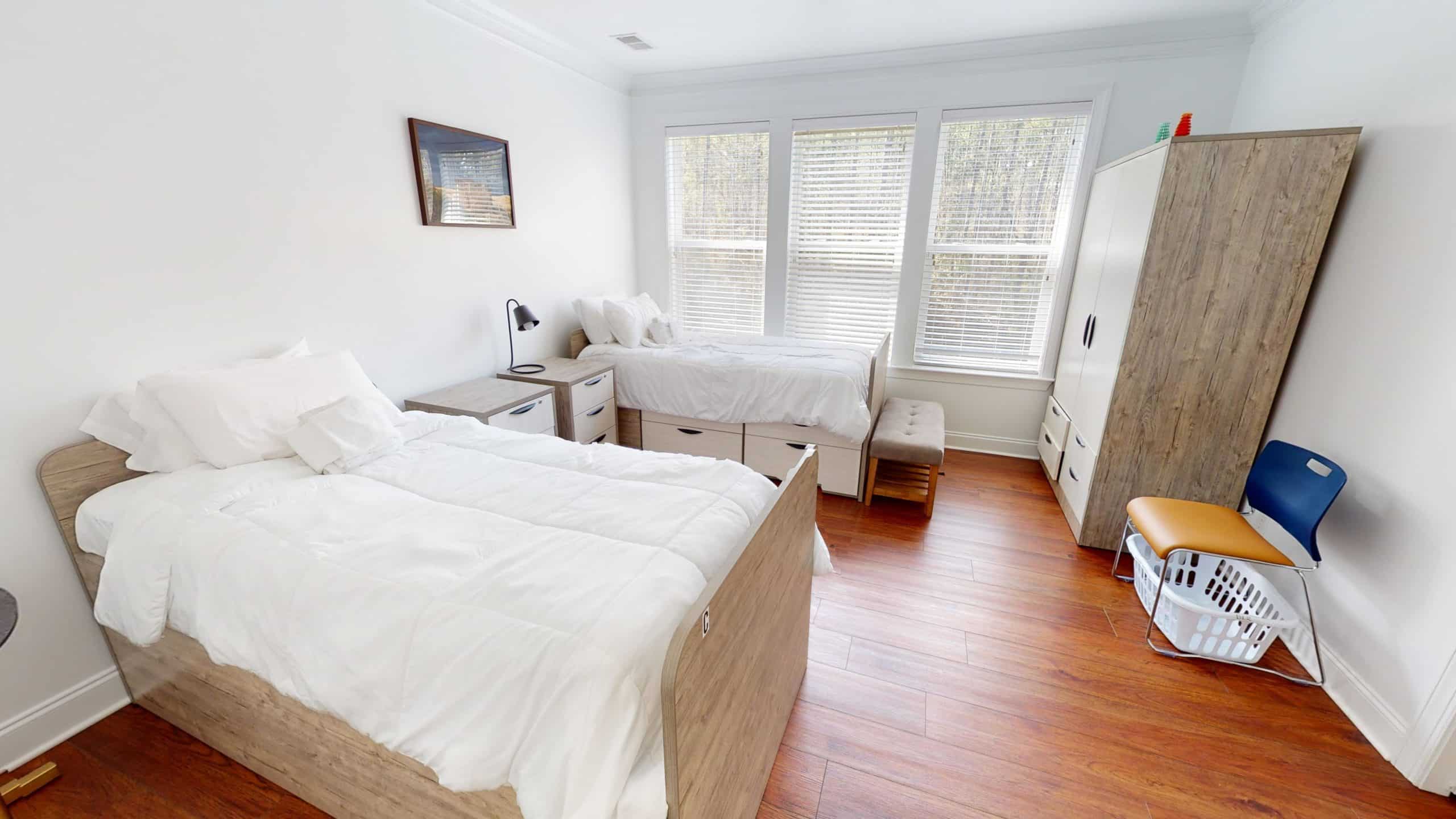 Bright bedroom with twin beds and large windows