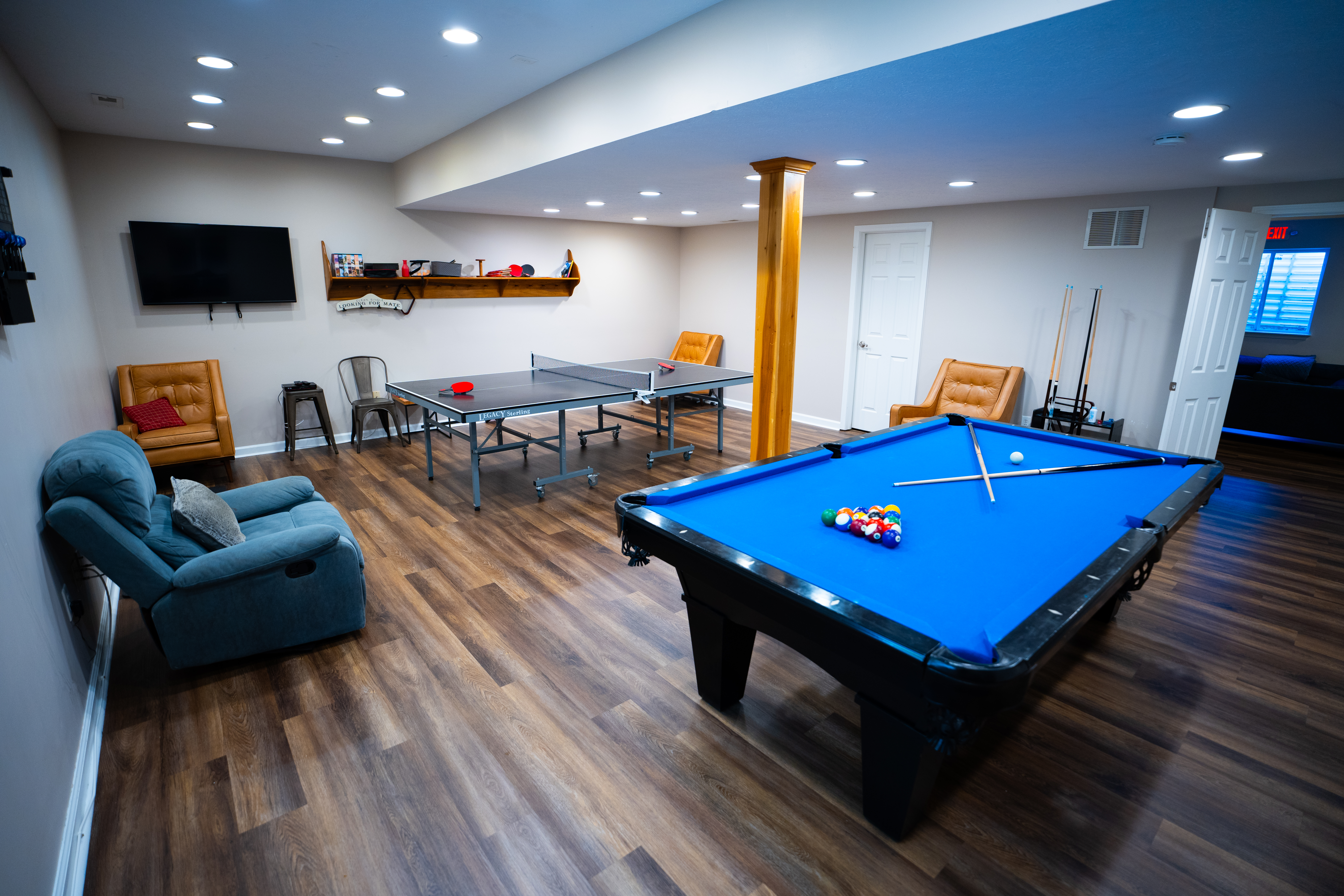 Game room with pool table, ping pong, and lounge seating