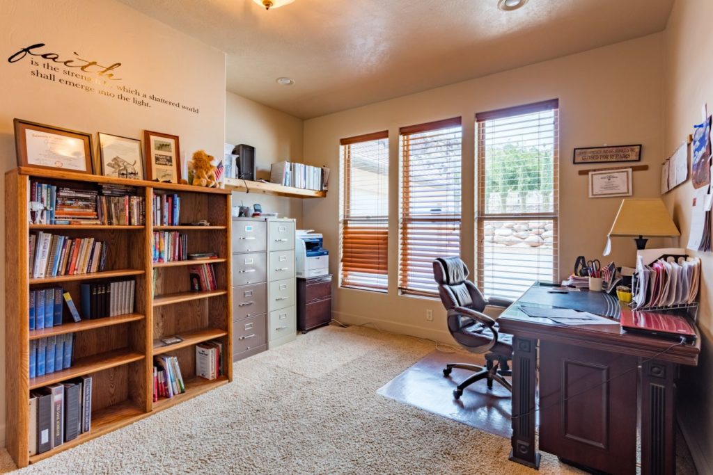 Office with bookshelves, desk, and large windows for counseling.