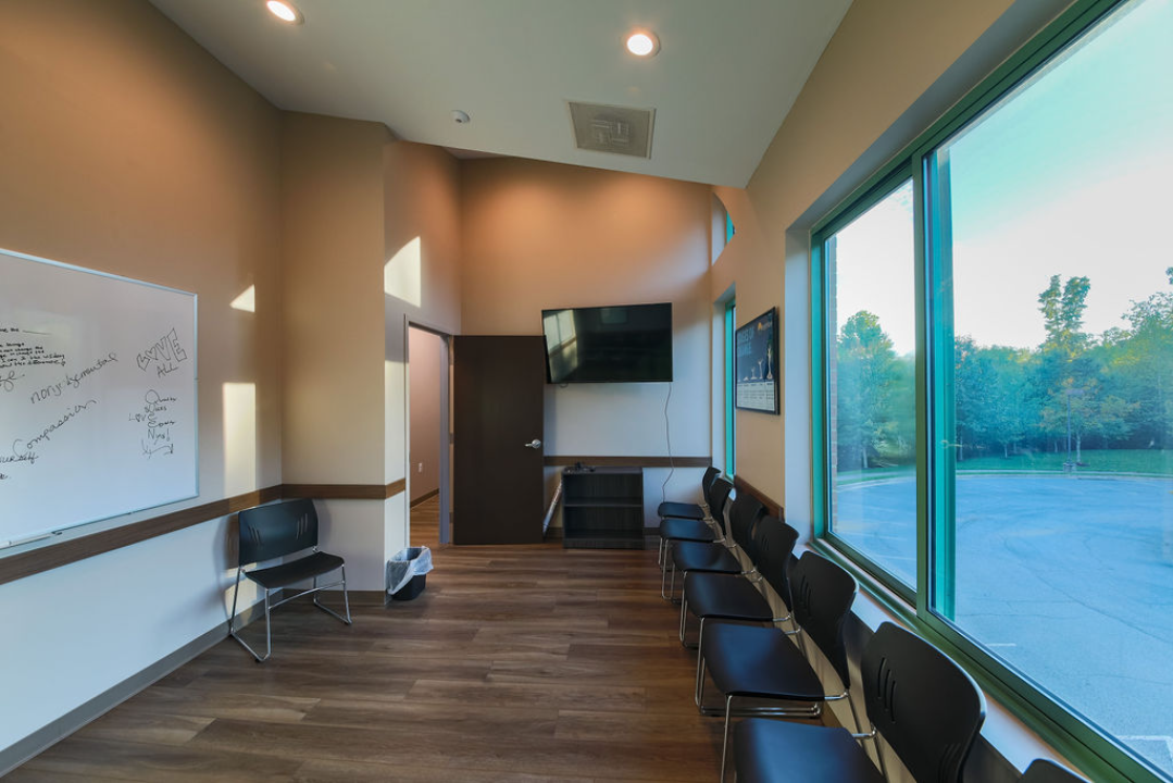 Counseling room with TV, whiteboard, and seating