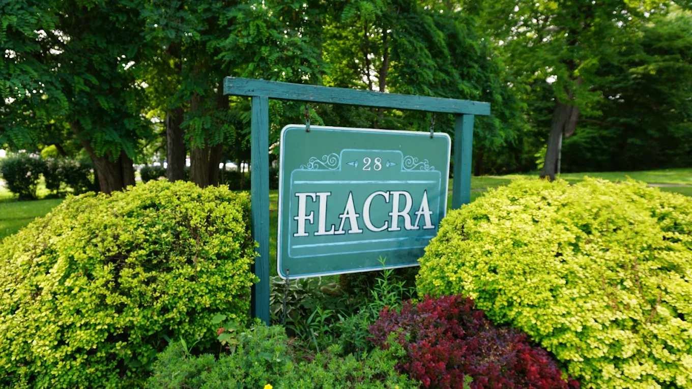 FLACRA facility sign surrounded by shrubs and trees
