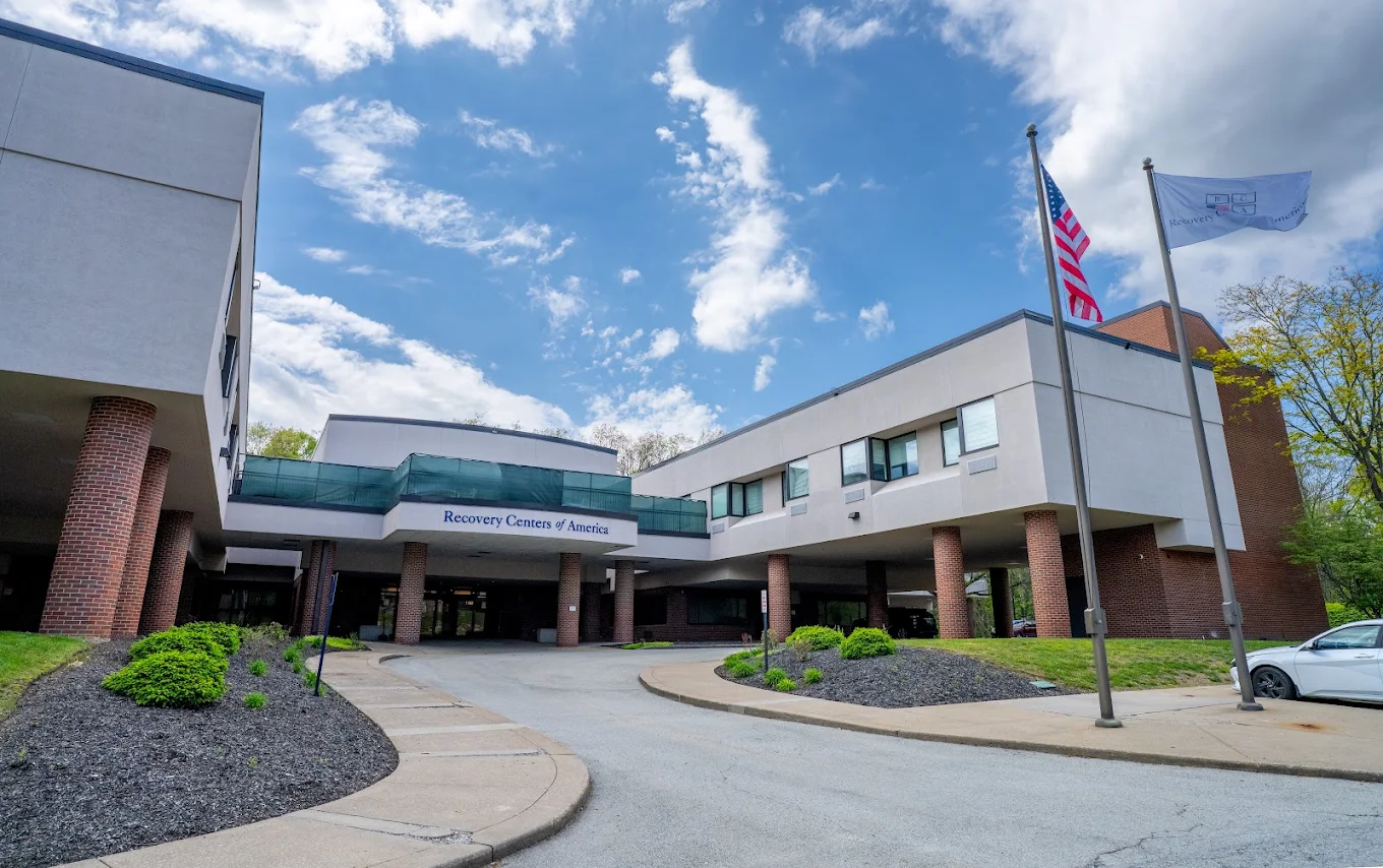 Front exterior of the facility with entrance and flagpoles