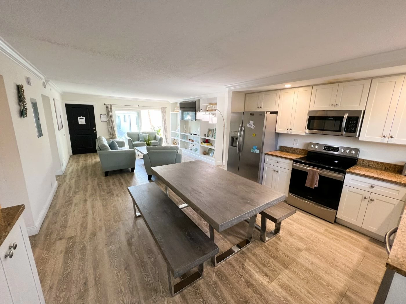 Modern shared kitchen with dining table and seating area for residents