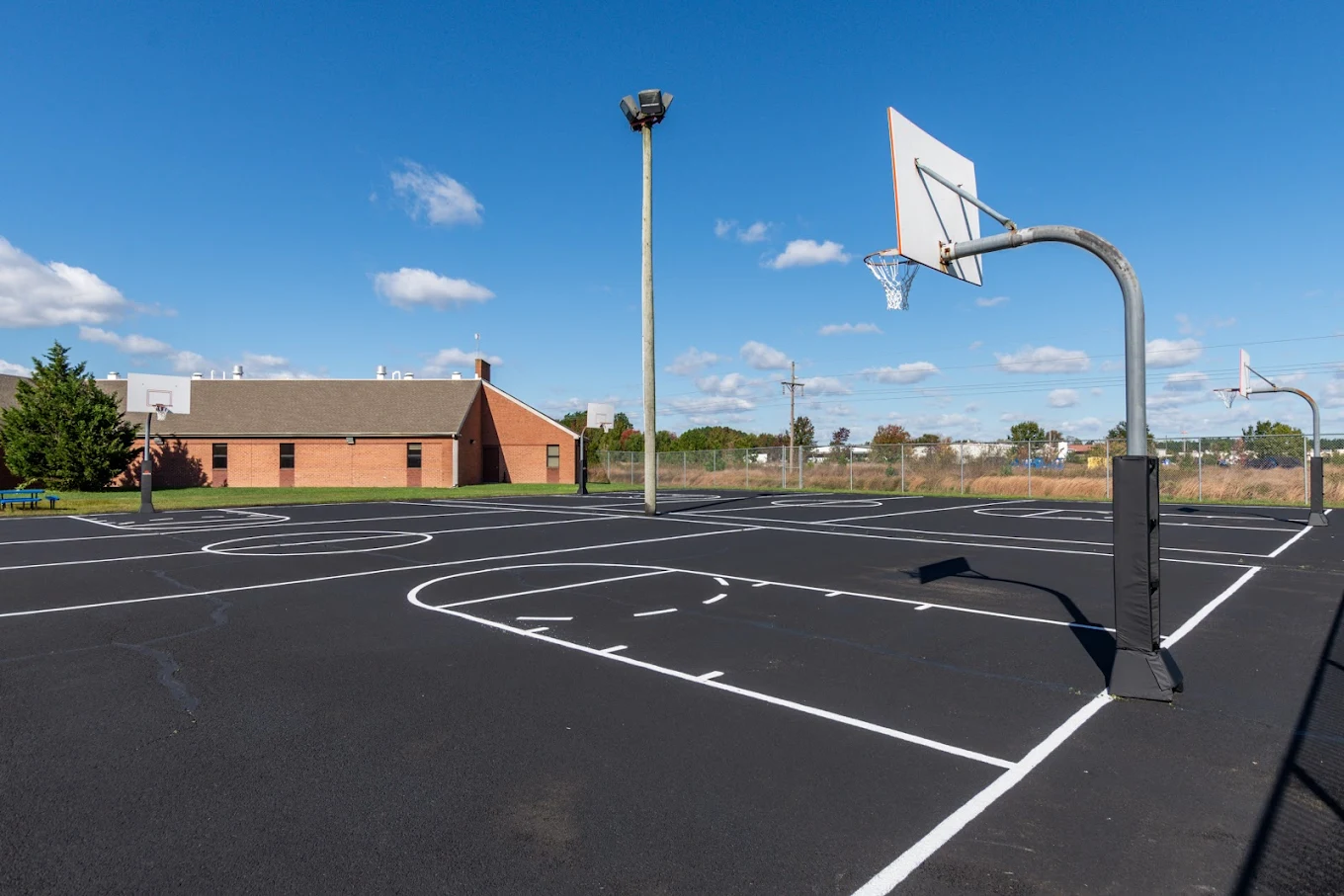 Outdoor basketball court with six hoops
